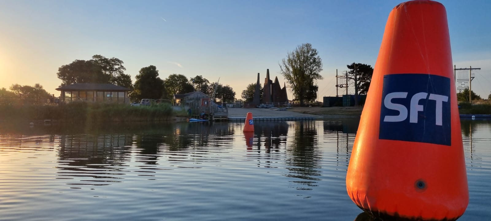 Swimmers entering the Stubbers Lake for an open water swim.